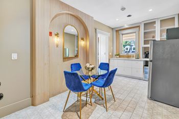 A dining area with a table and four chairs.